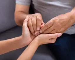 young hands holding older set of hands