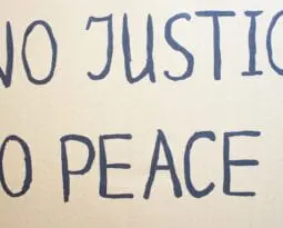 NO JUSTICE NO PEACE. Text message for protest on cardboard. Stop