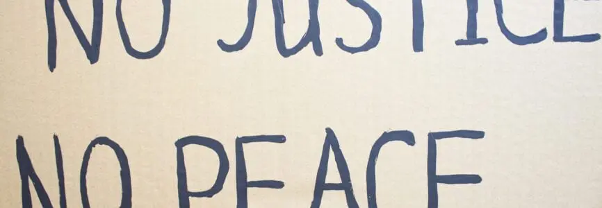 NO JUSTICE NO PEACE. Text message for protest on cardboard. Stop
