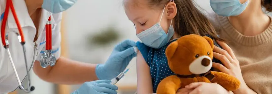 Doctor vaccinating child, kid with mother at hospital.