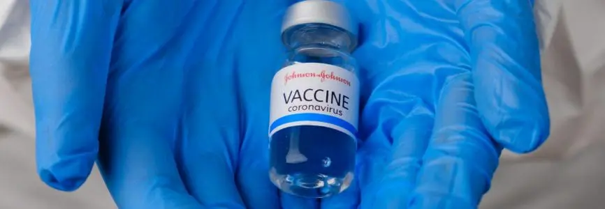 Johnson and johnson coronavirus vaccine in doctors or nurses hands in blue rubber gloves. Prevention of sars-cov-2 or Covid-19, January 2021, San Francisco, USA