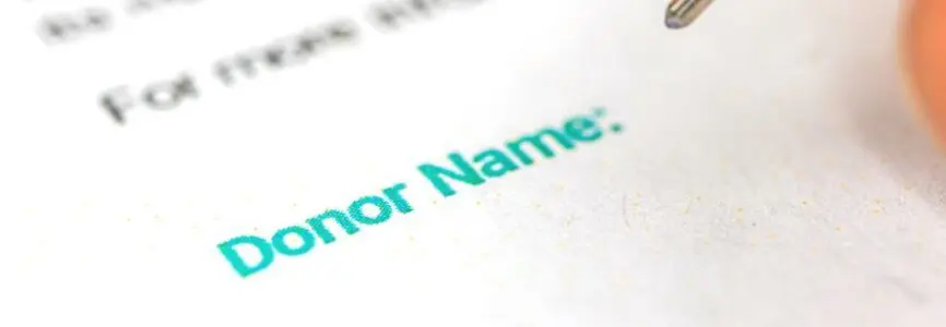 Donation form with donor name background, man is signature donation consent, charity concept photo