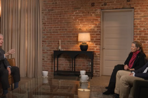 older white man talking to asian man and white woman