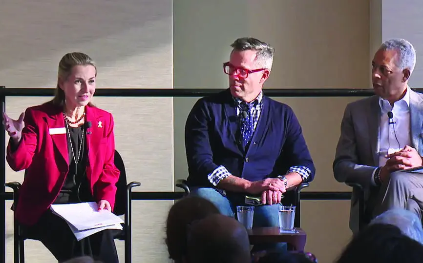 white woman on a panel with white man and black man