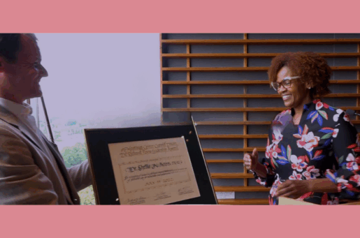 smiling african american woman receiving award