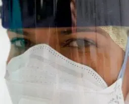 woman of color with a white mask and ear cover