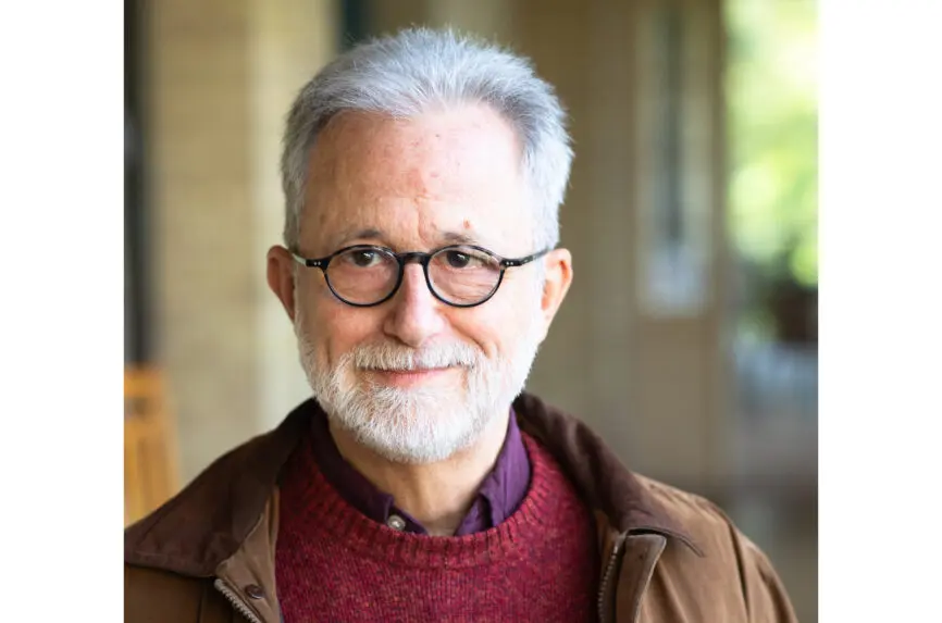 older gray white man with glasses and beard