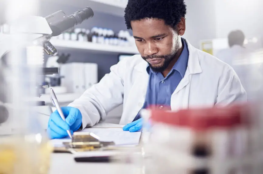 Black man writing report for science study, scientist in lab for research to test and experiment for scientific innovation. Biotechnology in laboratory, focus and knowledge, pen and checklist.