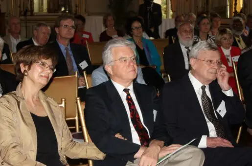 audience members listening, older white people