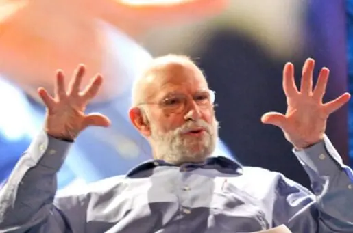 Oliver Sacks, bald, aging white man holding his hands up