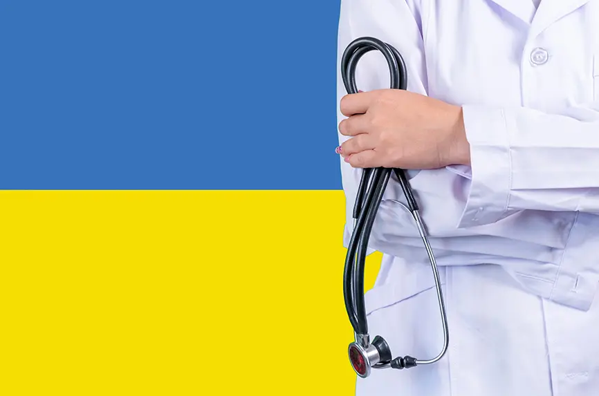 Female doctor with stethoscope in hand on the background of the Ukraine flag. Concept medicine, pandemic in the country
