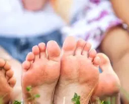 family sitting with feet towards camera