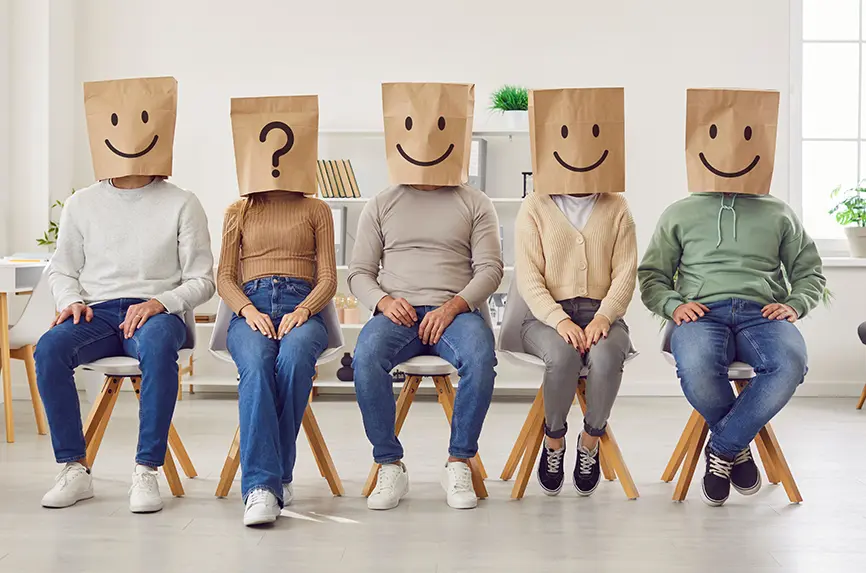 Group of unknown people with paper shopping package bags with emoticons on their heads