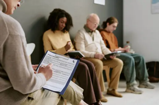 people in chairs in clinic waiting room