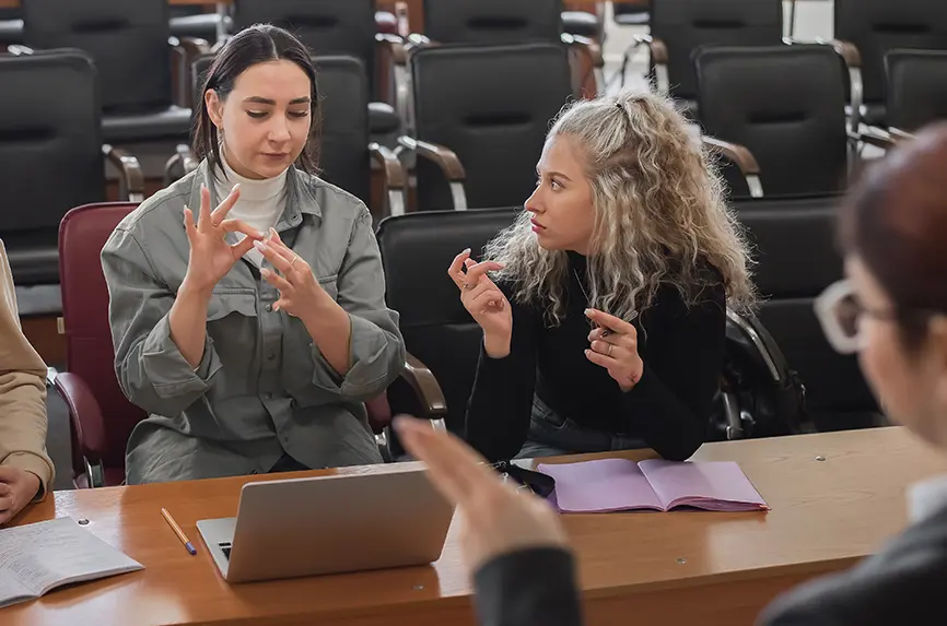 The teacher and students communicate in sign language in the classroom. Hearing impaired and deaf people