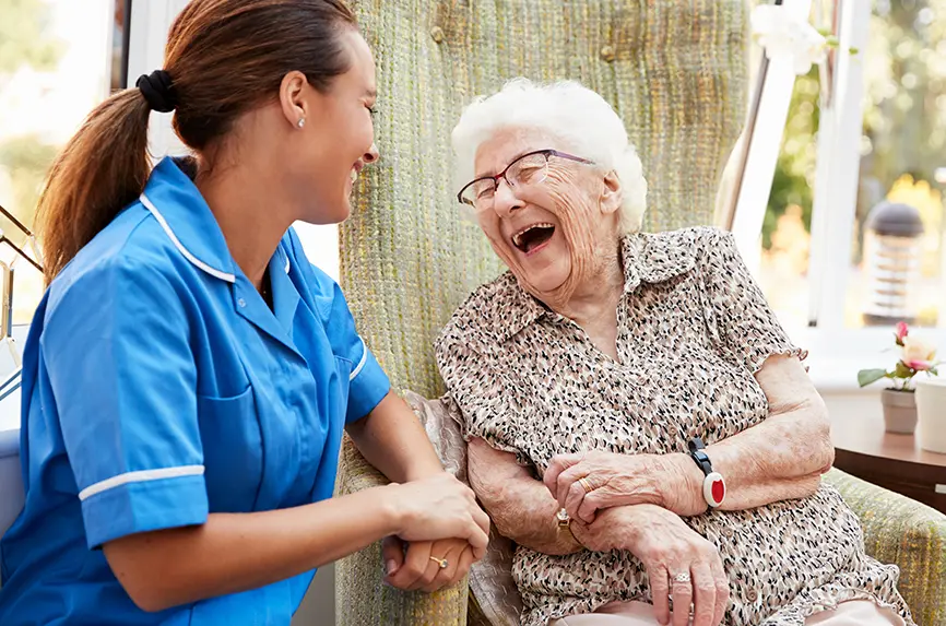 older white woman laughing with young smiling woman looking on
