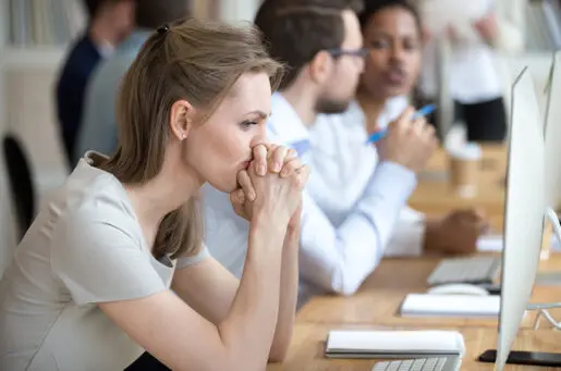 white woman leaning face on folded hands