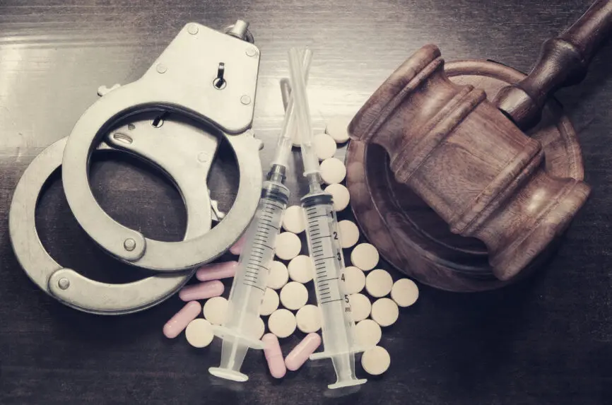 handcuffs, pills, gavel