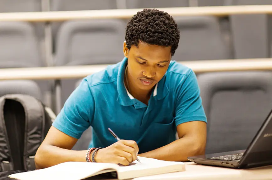 young black man writing