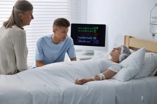 older woman and younger man by hospital bed