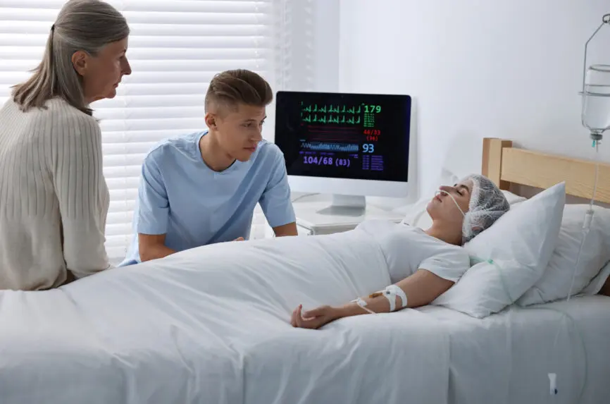 older woman and younger man by hospital bed