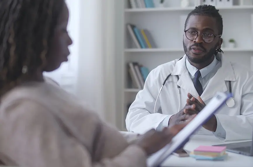 African American woman reading doctor prescription after healthcare check-up