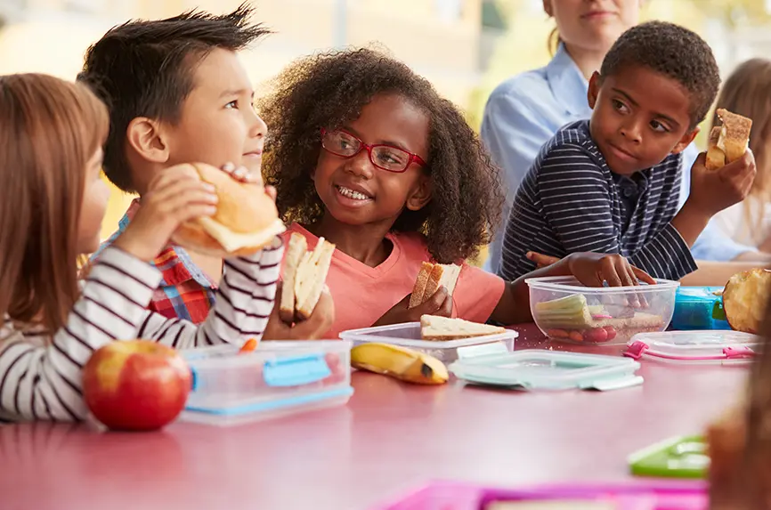 young school kids eating together
