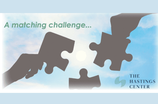 gray hands holding puzzle pieces against the sky