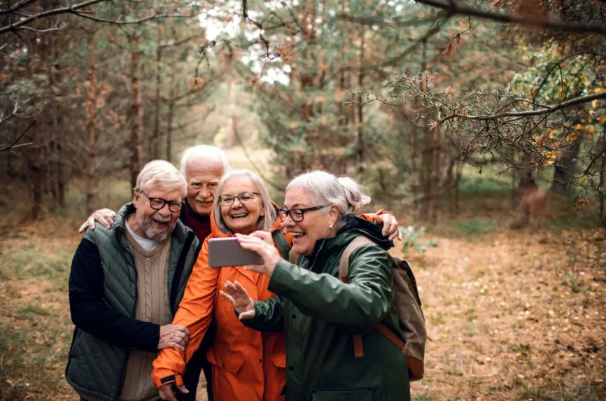 Group of senior friends taking a selfie during forest hike