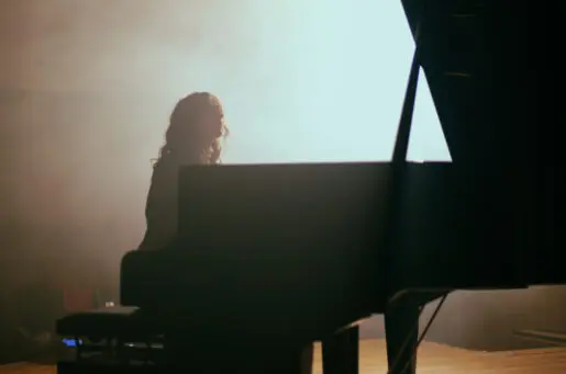 woman plays the piano in hall