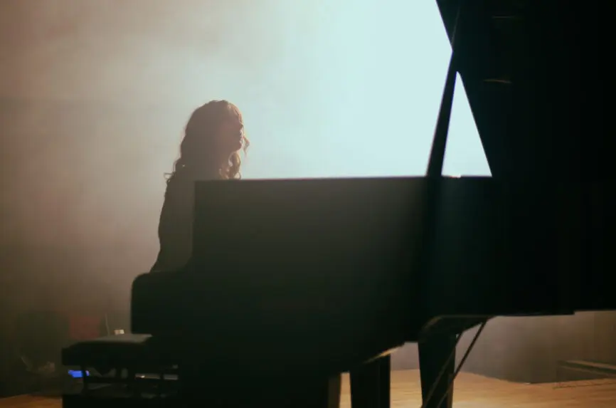 woman plays the piano in hall