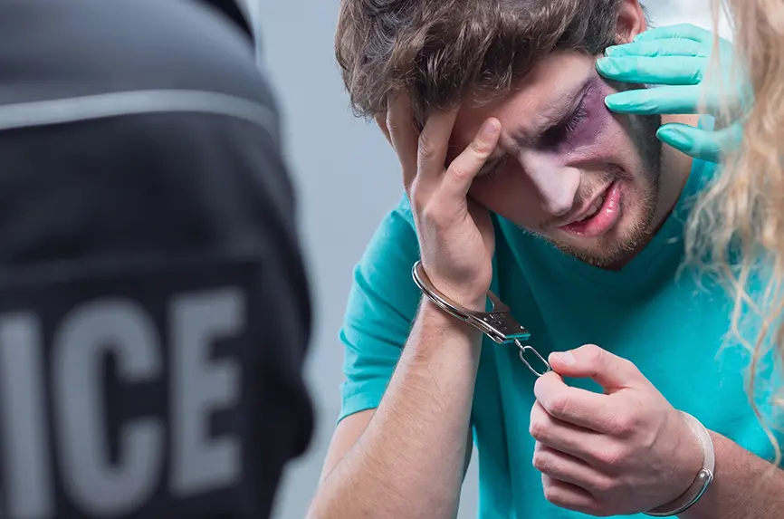 Handcuff bruised man in emergency room with police