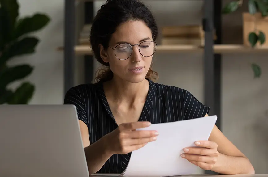young hispanic woman with glasses reading