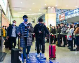 people with suitcases traveling in China