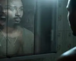 Black man looking in the mirror