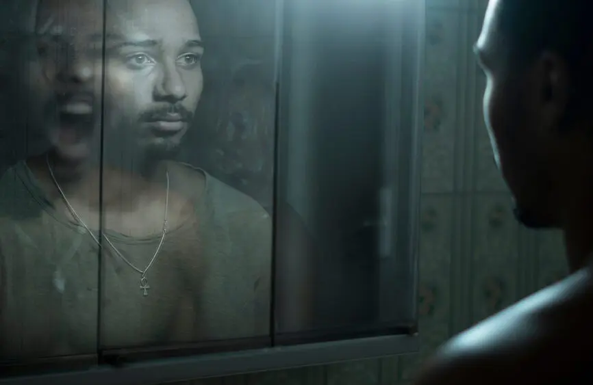 Black man looking in the mirror