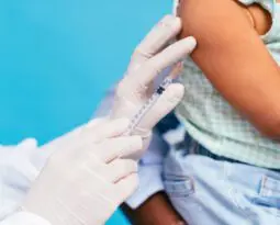 vaccine being injected into toddler's arm