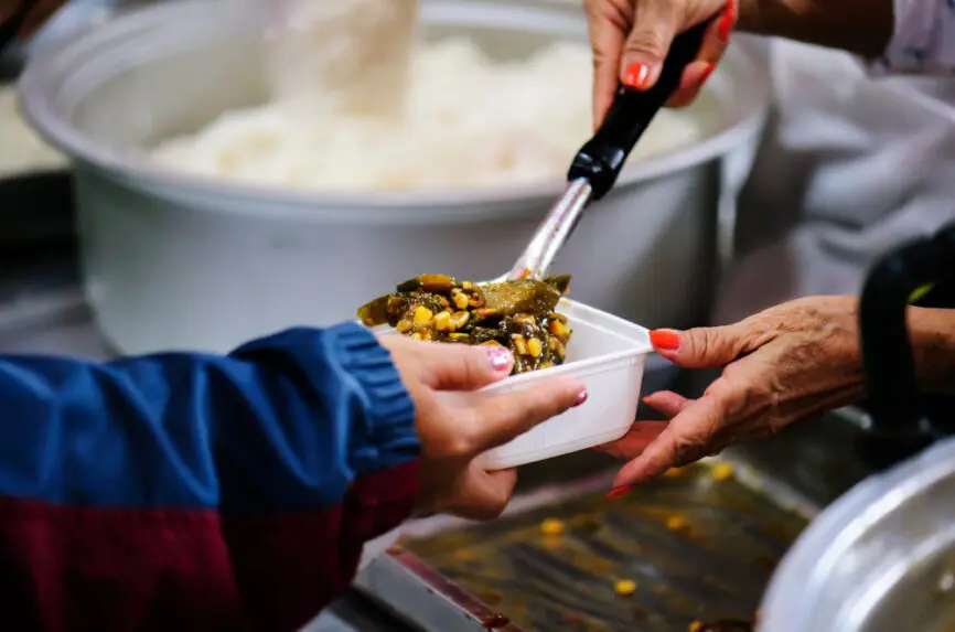 hands of someone receiving food at food pantry