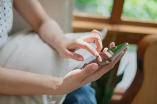 hands holding and touching cellphone