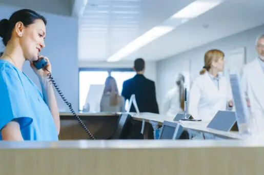 nurse on phone in hospital hallway