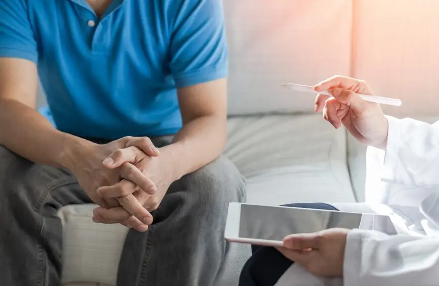 man sitting on bed, woman with ipad