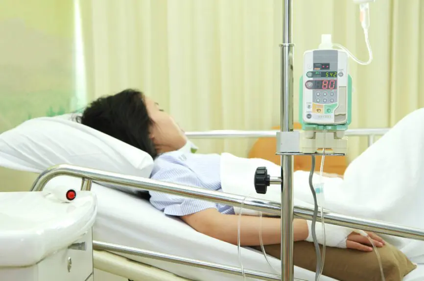 anesthetized female patient in hospital bed