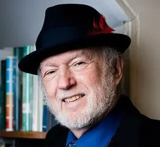 photo of an older bearded man with fedora
