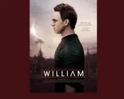 modern looking man facing left with cityskape behind him