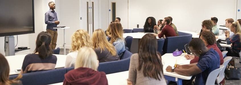 University students study in a classroom with male lecturer