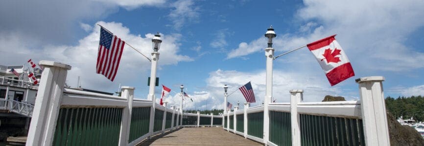 Roche Harbor - United States of America and Canada Flags Hang From the Dock