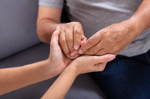 young hands holding older set of hands