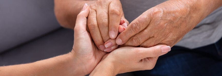 young hands holding older set of hands