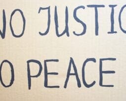 NO JUSTICE NO PEACE. Text message for protest on cardboard. Stop