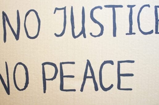 NO JUSTICE NO PEACE. Text message for protest on cardboard. Stop